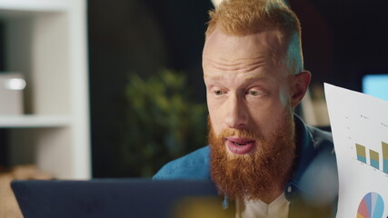 Closeup angry businessman making video call on laptop computer at home office