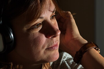 Young woman listening to music with headphones.