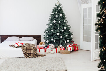 New Year's card bedroom interior with red bed decor and Christmas tree with gifts