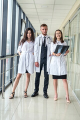 Group of young doctors discuss and looking x-ray scan leg in a clinic