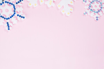 Snowflakes at the top on a pink background.