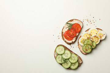 Tasty toasts with different topping on white background