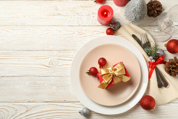 Concept of New year table setting with gift box on wooden table