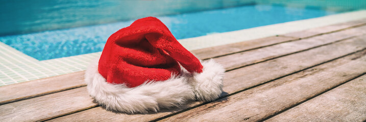 Christmas background banner santa claus red hat on swimming pool vacation holiday resort horizontal...