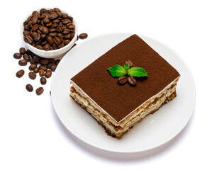 Traditional Italian Tiramisu square dessert portion on ceramic plate and coffee beans isolated on white background with clipping path