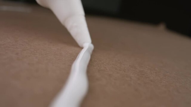 A person applies PVA glue to the&nbsp;surface.&nbsp;Close-up.