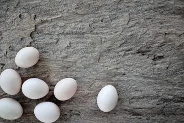 Top view of fresh organic chicken eggs in rustic natural wooden background with copy space. 