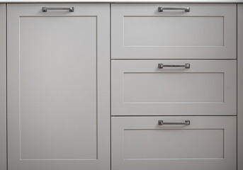 White kitchen cabinets with metal pulls or knobs on the doors. - obrazy, fototapety, plakaty