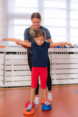 Child training for balance improvement and flat feet correction, walking over spiked half-balls
