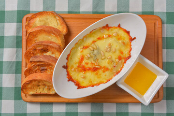 Zucchini baked with cheese in a dish, close up food. Delicious meat and cheese casserole. Italian cuisine concept.