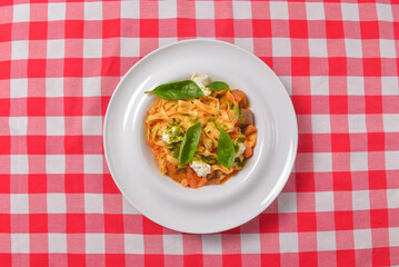 Italian penne pasta or noodles with a savory tomato sauce, fresh basil and grated parmesan cheese.
