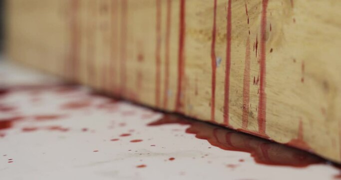 Red blood liquid dripping down a wooden wall, Halloween concept.