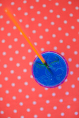 Blue curacao cocktail drink in glass with ice and lemon outside. Cold refreshing summer beverage.