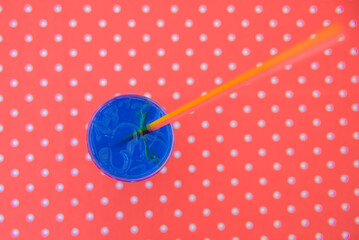 Blue curacao cocktail drink in glass with ice and lemon outside. Cold refreshing summer beverage.