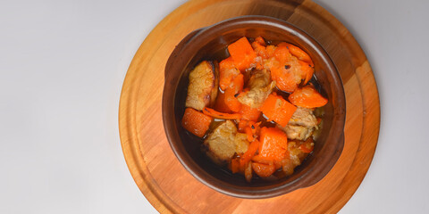 Meat pieces with pumpkin and tomato, mincemeat dish with fresh thyme.