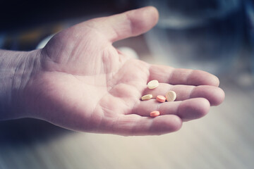 hand of an adult man with pills