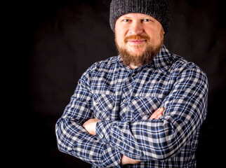 Fototapeta premium Solid bearded man in a wool cap portrait