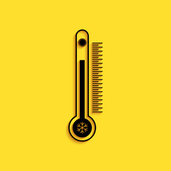 Black Thermometer with scale measuring heat and cold, with sun and snowflake icon isolated on yellow background. Long shadow style. Vector.