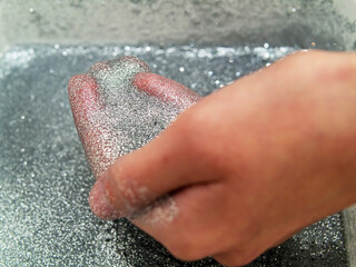 Child hand in hand made slime with glitter. Selective focus. Concept art and child development through art.