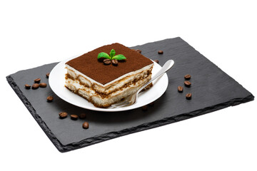 Traditional Italian Tiramisu square dessert portion on ceramic plate and coffee beans on stone serving cutting board isolated on white