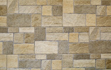 Stoneware tiles for exterior wall cladding with rock effect. Colors are shades of brown. Background...