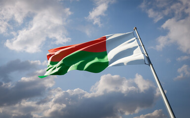 Madacascar national flag waving at sky background close-up.