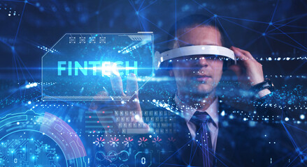 Business, Technology, Internet and network concept. Young businessman working on a virtual screen of the future and sees the inscription: Fintech