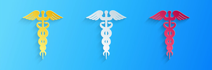 Fototapeta na wymiar Paper cut Caduceus medical symbol icon isolated on blue background. Medicine and health care concept. Emblem for drugstore or medicine, pharmacy snake. Paper art style. Vector.