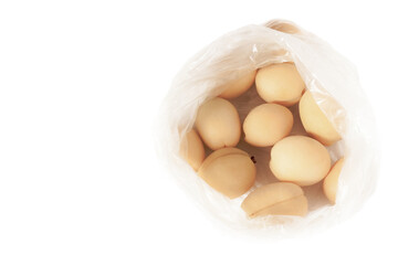 Fresh apricots in plastic cellophane transparent package above view  retro style.