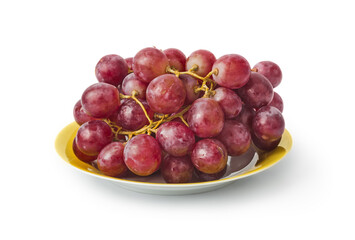 Ripe grapes on yellow plate