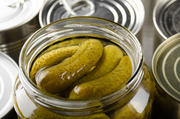 Canned pickles in just opened glass mason jar. Non-perishable food