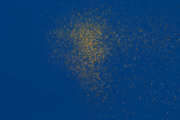 Gold glitter on blue background. Holiday abstract texture