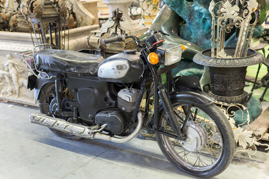 Old Black Motorcycle For Sale in an Antique Shop