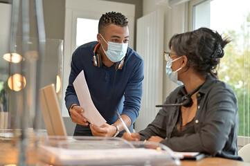 Start-up people working in co-working space office, wearing face mask during 19-ncov pandemic