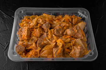 Beef or pork meat with stewed cabbage ready to eat, vacuum packed. Semi-finished product for restaurant and home. Food delivery.