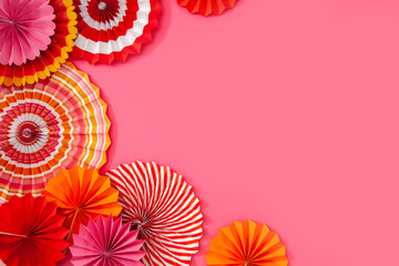 Colorful paper rosette and birthday garlands. Decorating for a party. Round, bright and color...