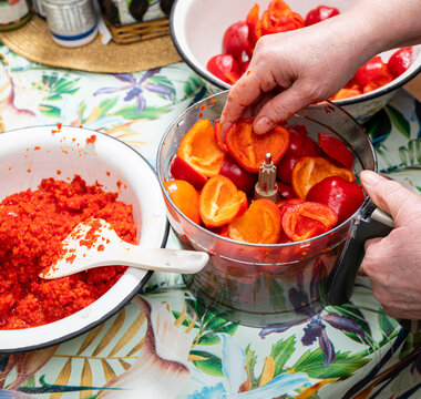 Woman preparing adjika sauce at home