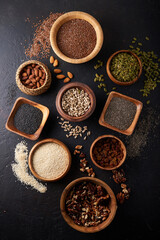 Seeds and nuts in different bowls. Walnut, sesame, pumpkin seed, almond, cinnamon Healthy breakfast
