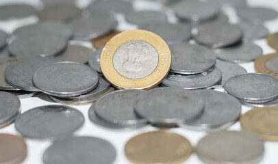 Indian rupee coins scattered on white background