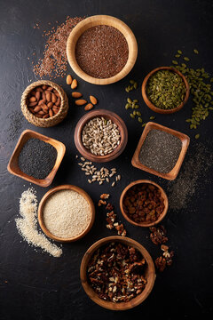 Seeds and nuts in different bowls. Walnut, sesame, pumpkin seed, almond, cinnamon Healthy breakfast © Natalya