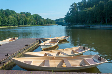 Pier on the lake with boats for walking on the water. Selective focus