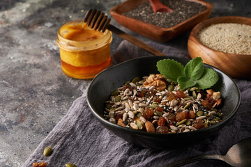 Healthy breakfast, seed and nut mix with honey and mint