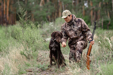 Hunting Dog Taking Smell Man with Rifle in Forest.