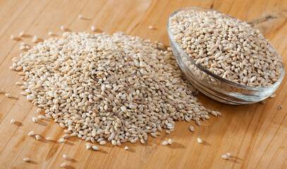 Pearl barley on a wooden surface, macro. High quality photo