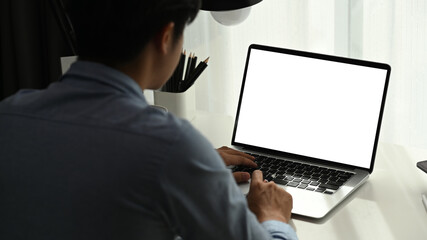 A professional investor man is working with new startup project on laptop at modern office.