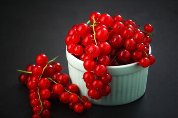 A ceramic bowl with red currant berries
