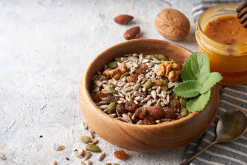 Healthy breakfast, seed and nut mix with honey and mint