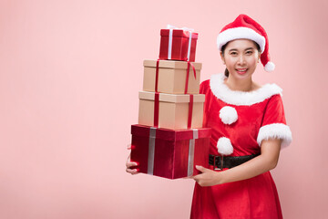 A beautiful woman in Santa Claus costume with many gift boxes on occasion of the Merry Christmas...