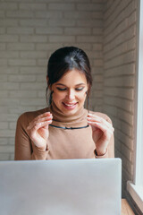 Young business woman working on computer at her home office