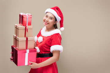 A beautiful woman in Santa Claus costume with many gift boxes on occasion of the Merry Christmas and Happy New Year